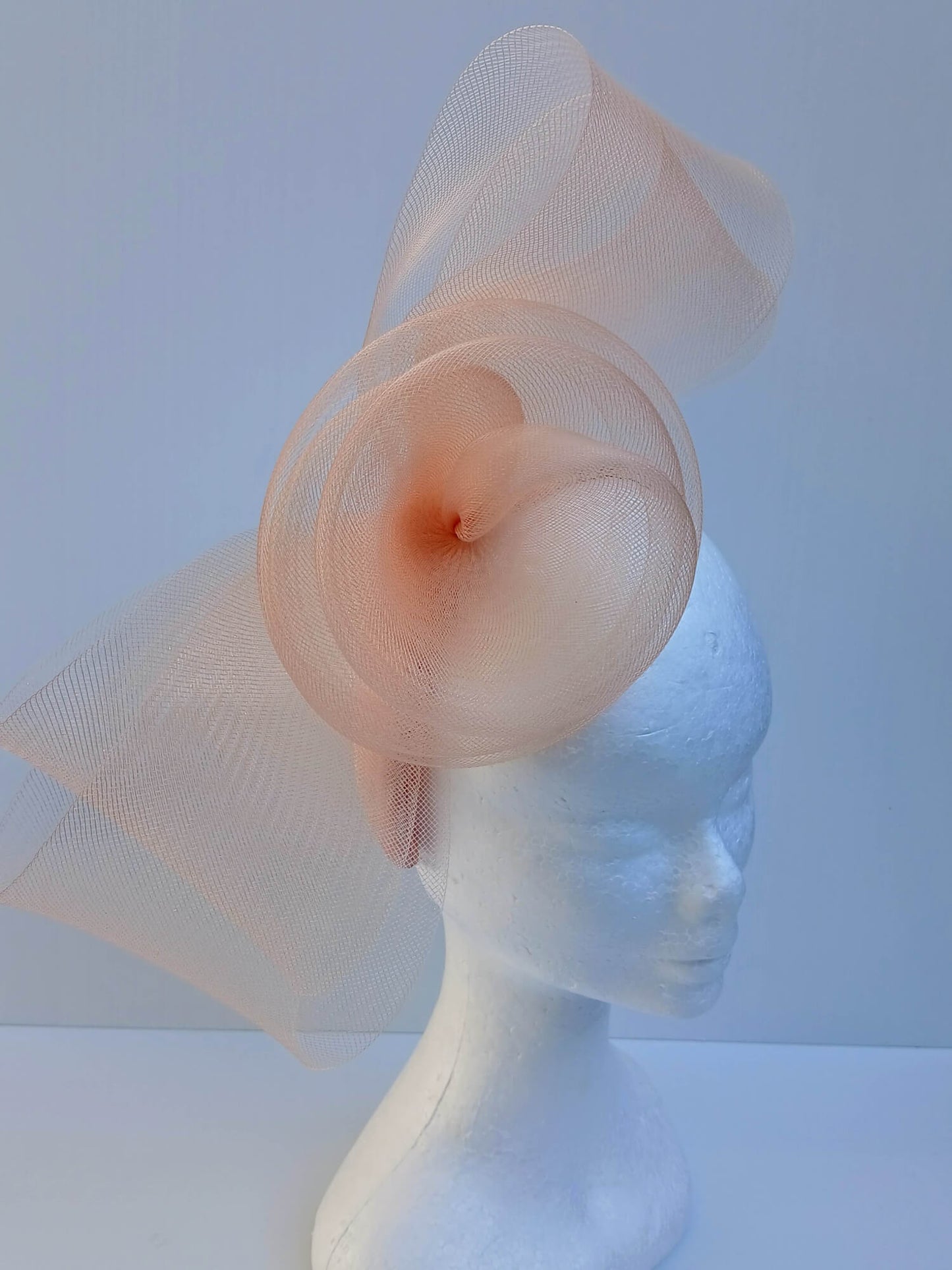 A picture of an Apricot Crinoline Bow and Rose Headband by Melissa Rath Millinery.