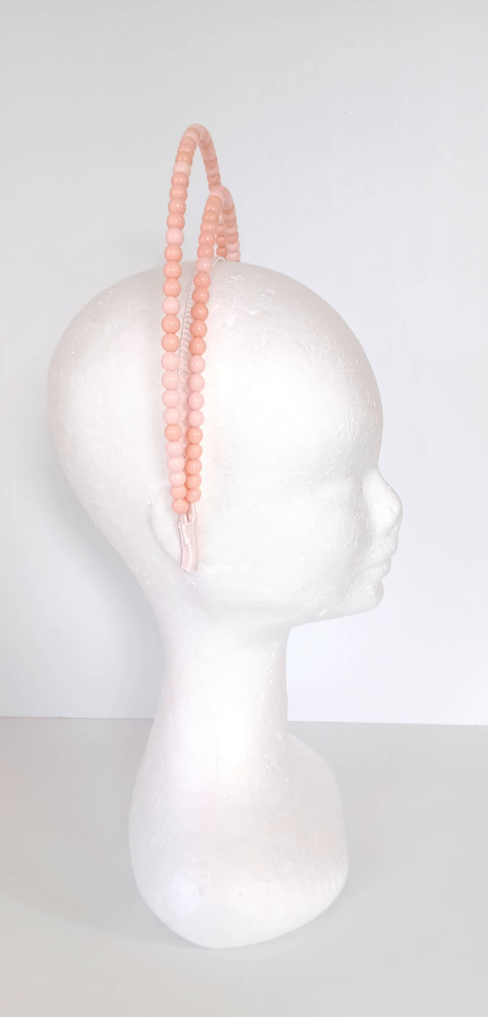 A picture of an Apricot Beaded Headband by Melissa Rath Millinery.