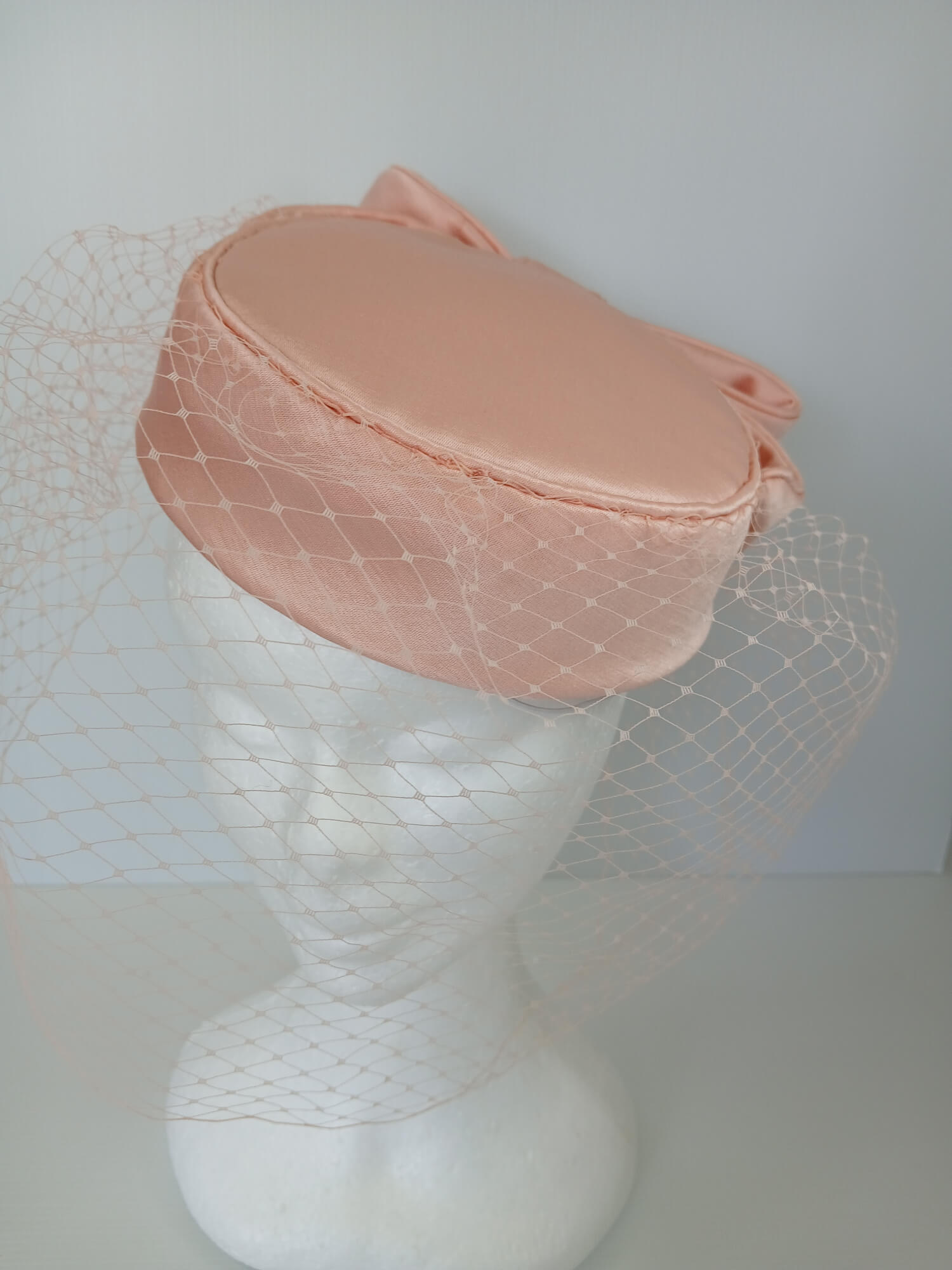 A picture of an Apricot Pillbox Hat  by Melissa Rath Millinery.
