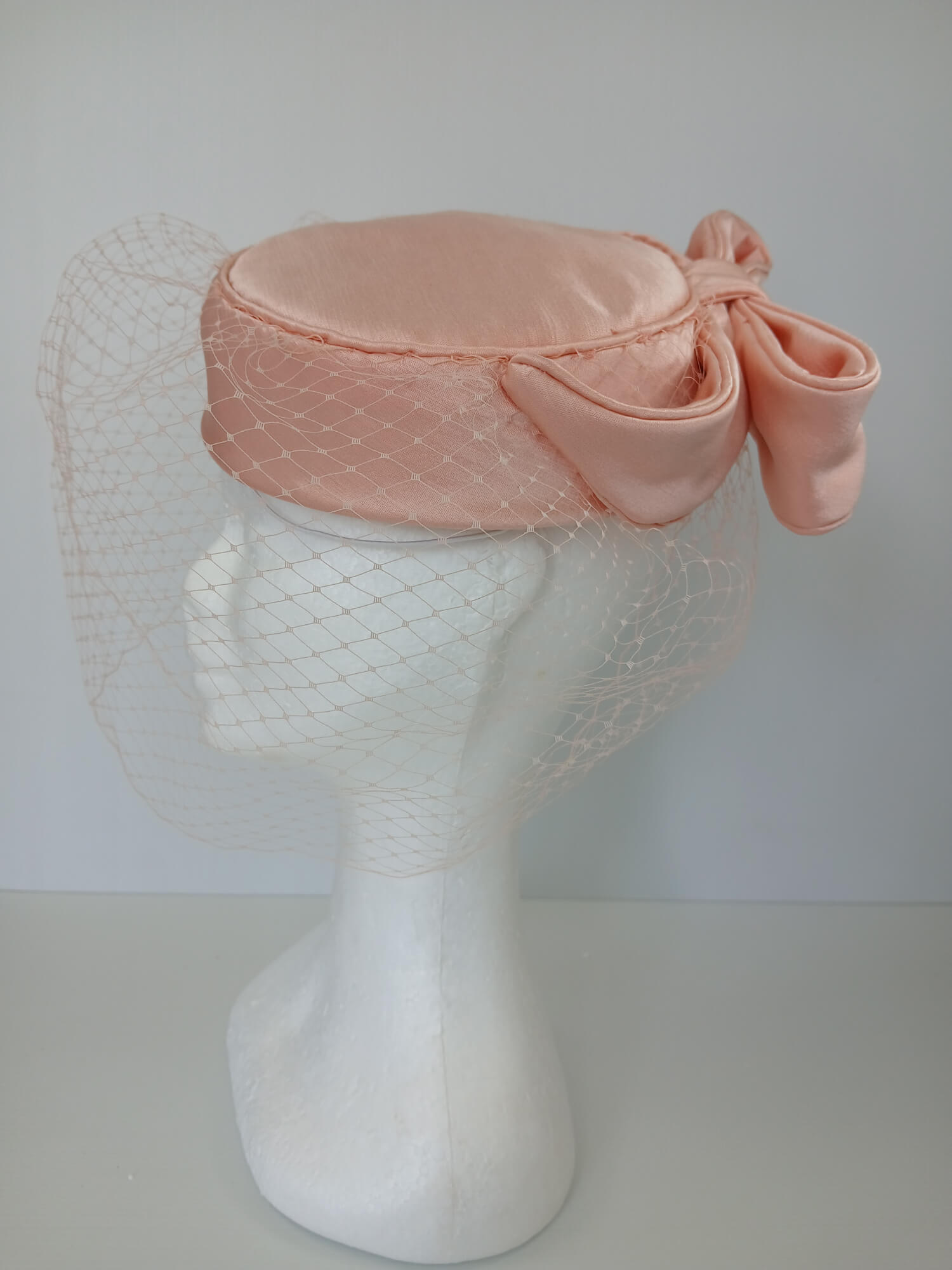 A picture of an Apricot Pillbox Hat  by Melissa Rath Millinery.