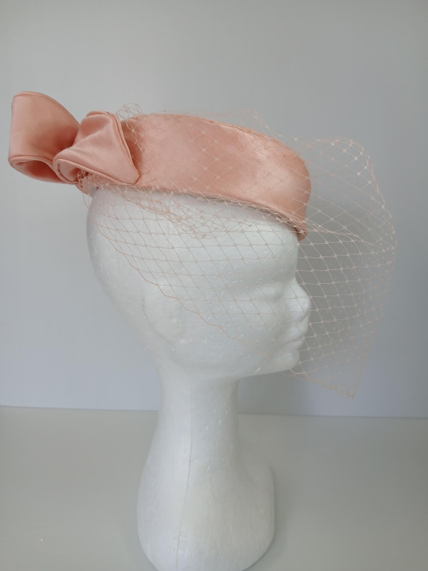 A picture of an Apricot Pillbox Hat  by Melissa Rath Millinery.