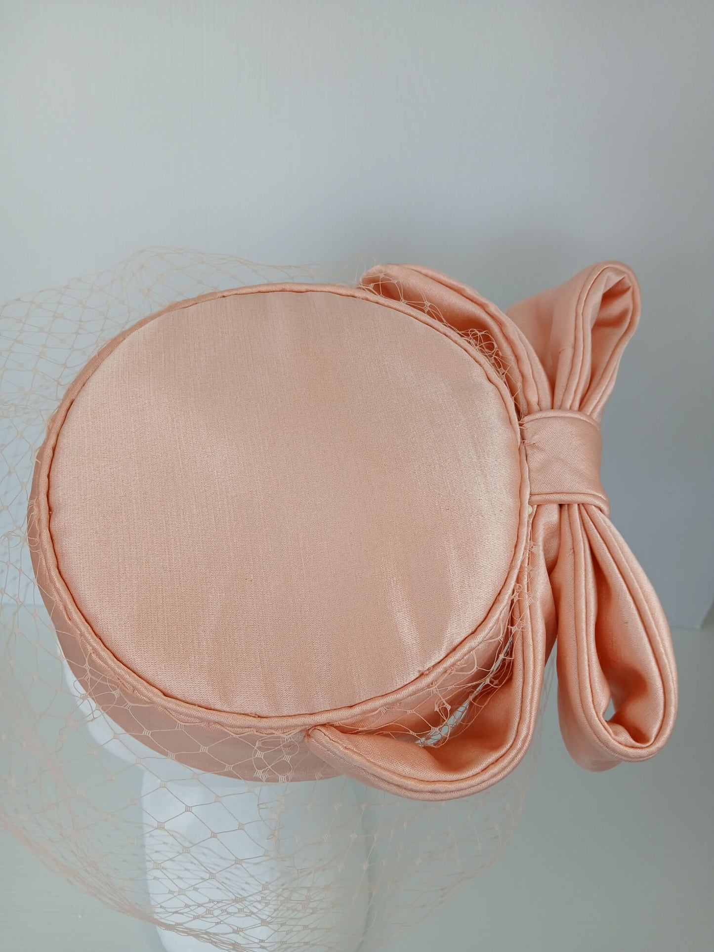 A picture of an Apricot Pillbox Hat  by Melissa Rath Millinery.