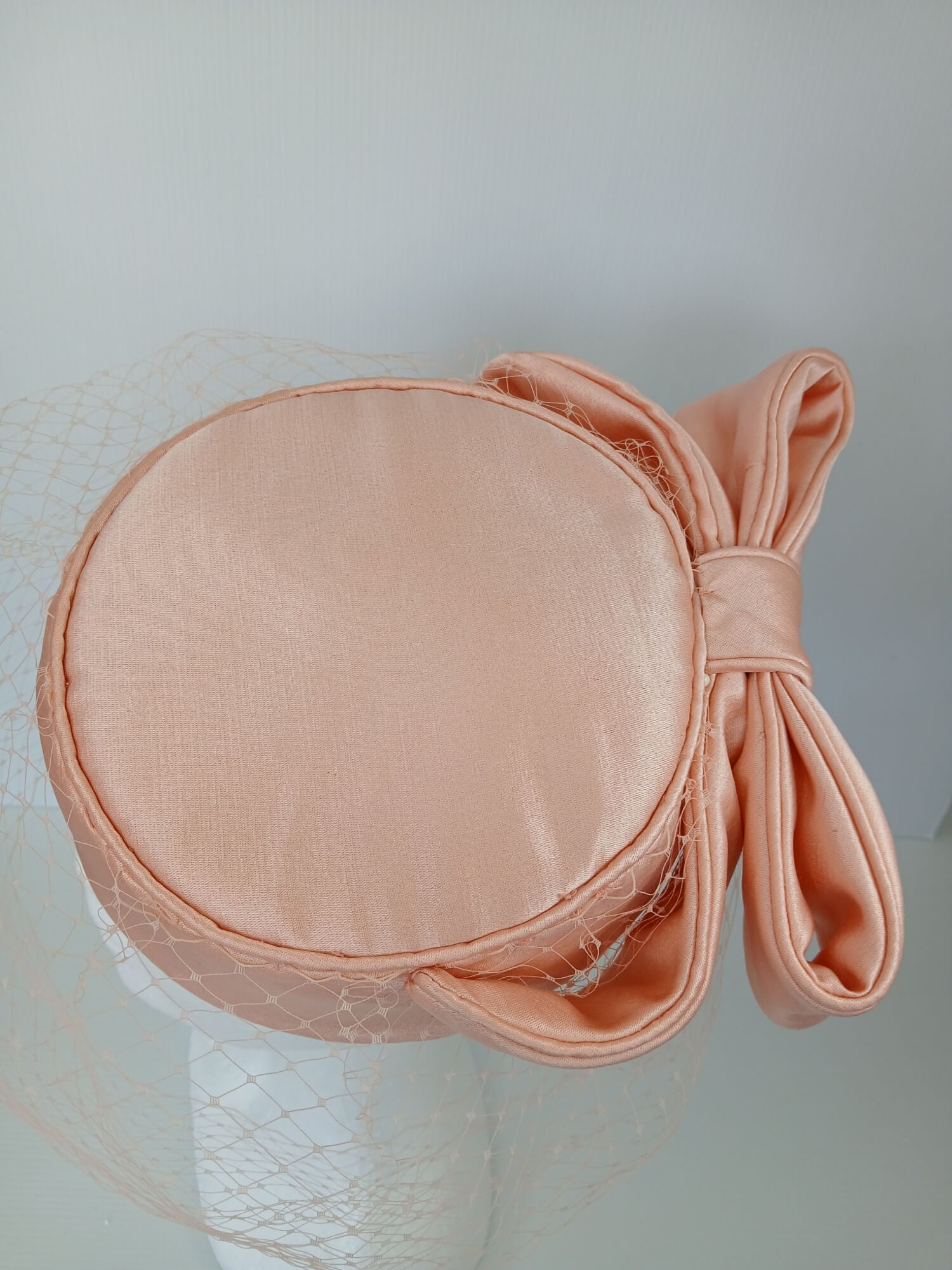 A picture of an Apricot Pillbox Hat  by Melissa Rath Millinery.