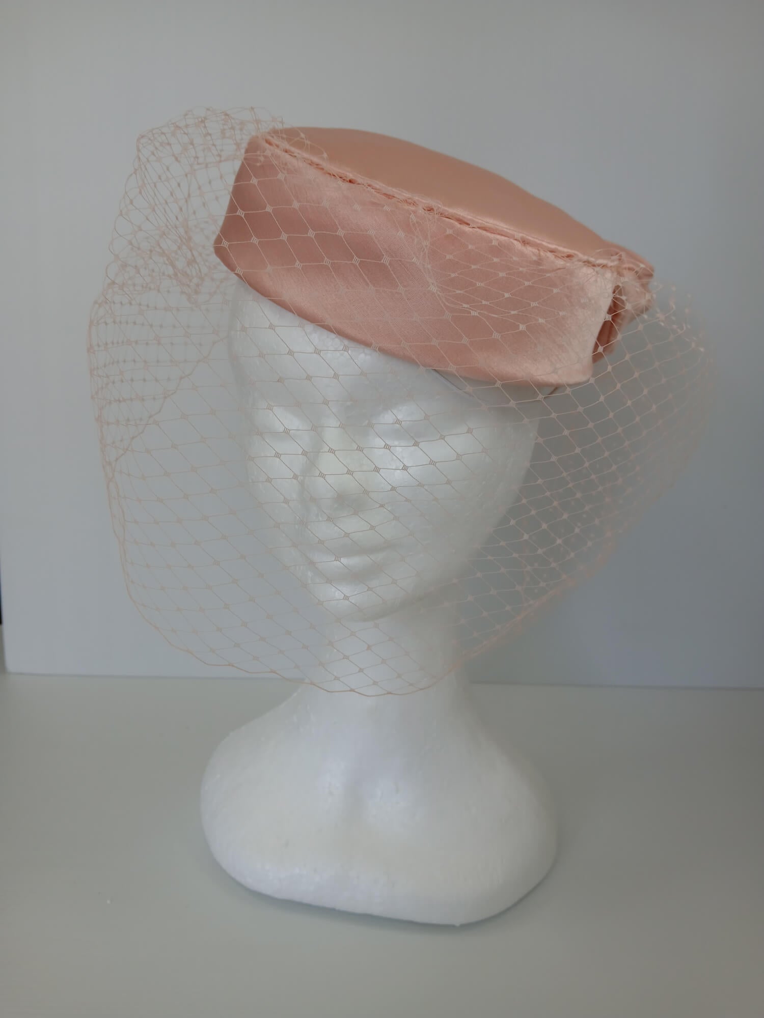 A picture of an Apricot Pillbox Hat  by Melissa Rath Millinery.