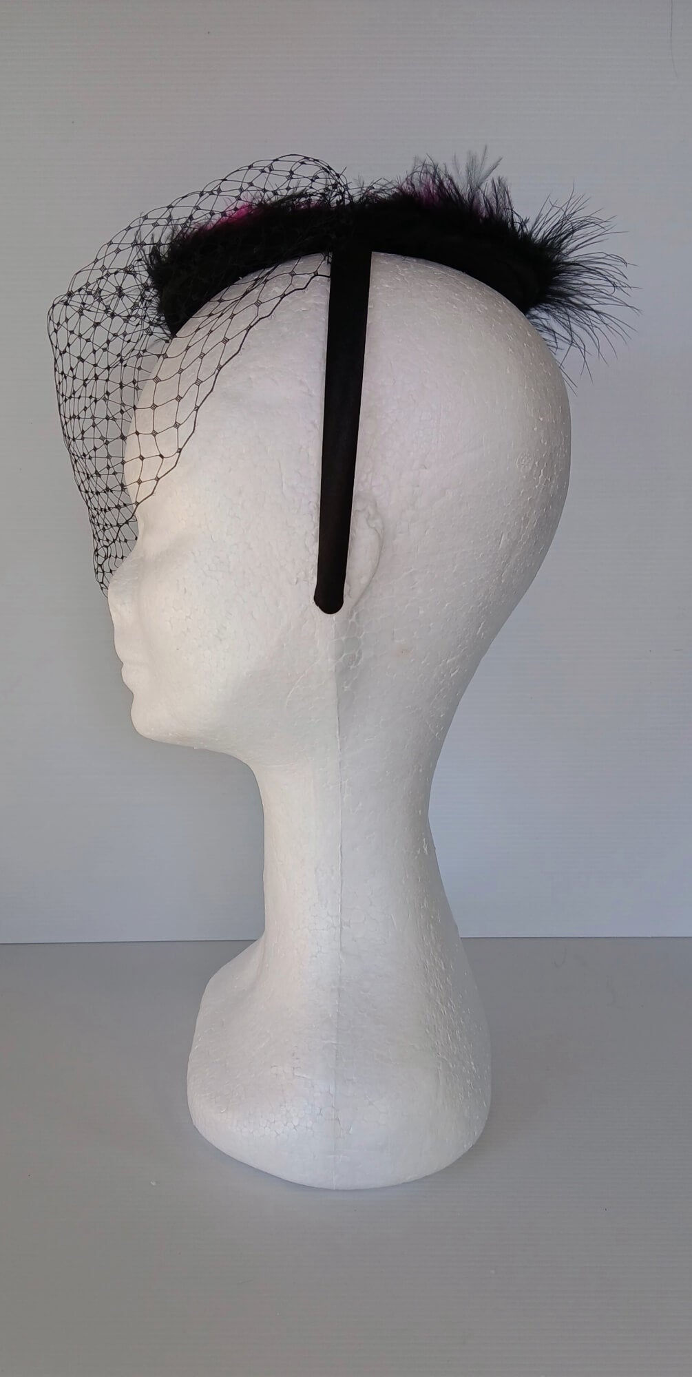 A picture of a Pink and Black Veiled and Feathered Millinery Fascinator by Melissa Rath Millinery.