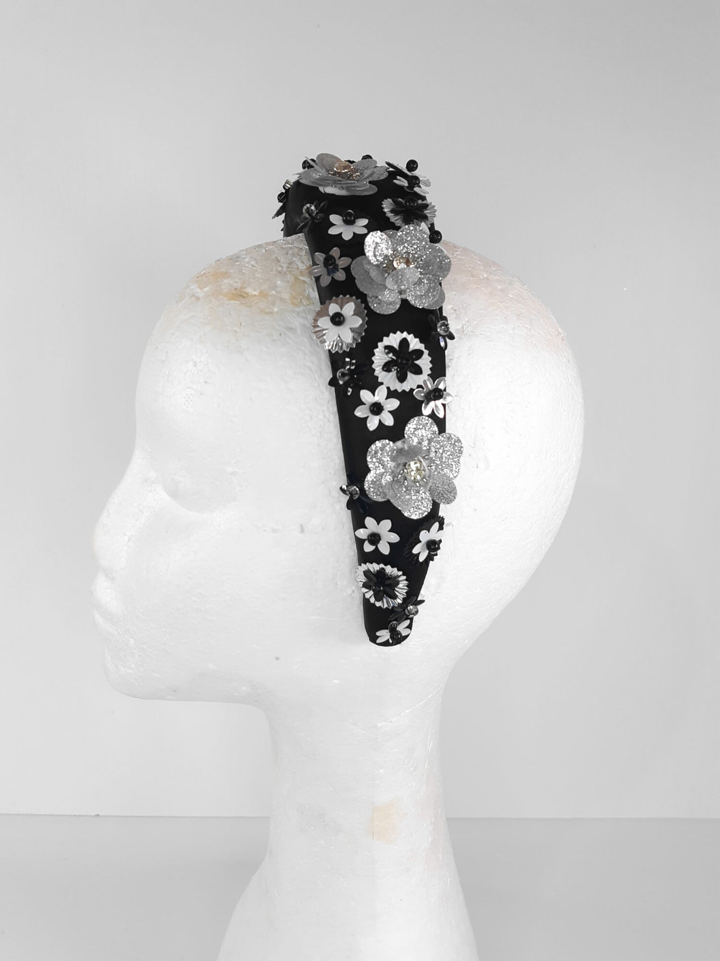 A picture of a Black, White and Silver Padded Headband by Melissa Rath Millinery.