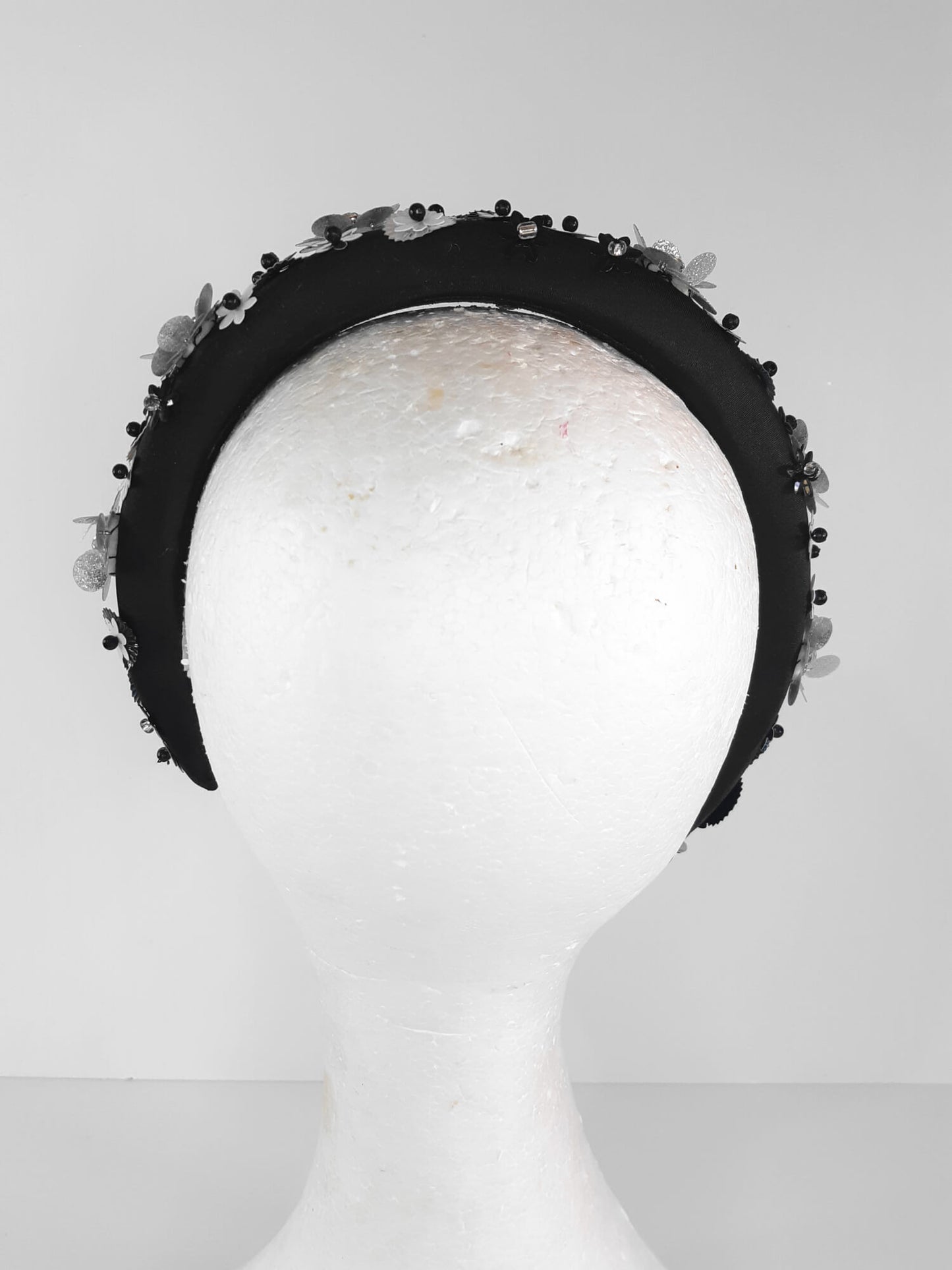 A picture of a Black, White and Silver Padded Headband by Melissa Rath Millinery.