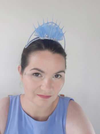 A picture of a blue feathered millinery crown by Melissa Rath Millinery.