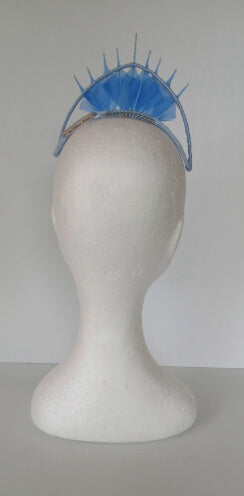 A picture of a blue feathered millinery crown by Melissa Rath Millinery.