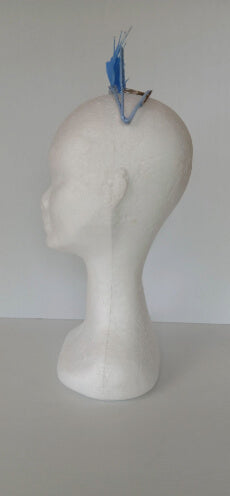 A picture of a blue feathered millinery crown by Melissa Rath Millinery.
