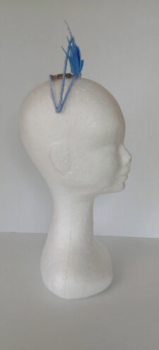 A picture of a blue feathered millinery crown by Melissa Rath Millinery.