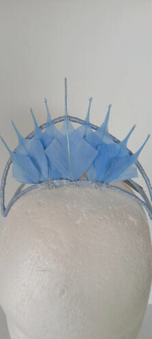 A picture of a blue feathered millinery crown by Melissa Rath Millinery.