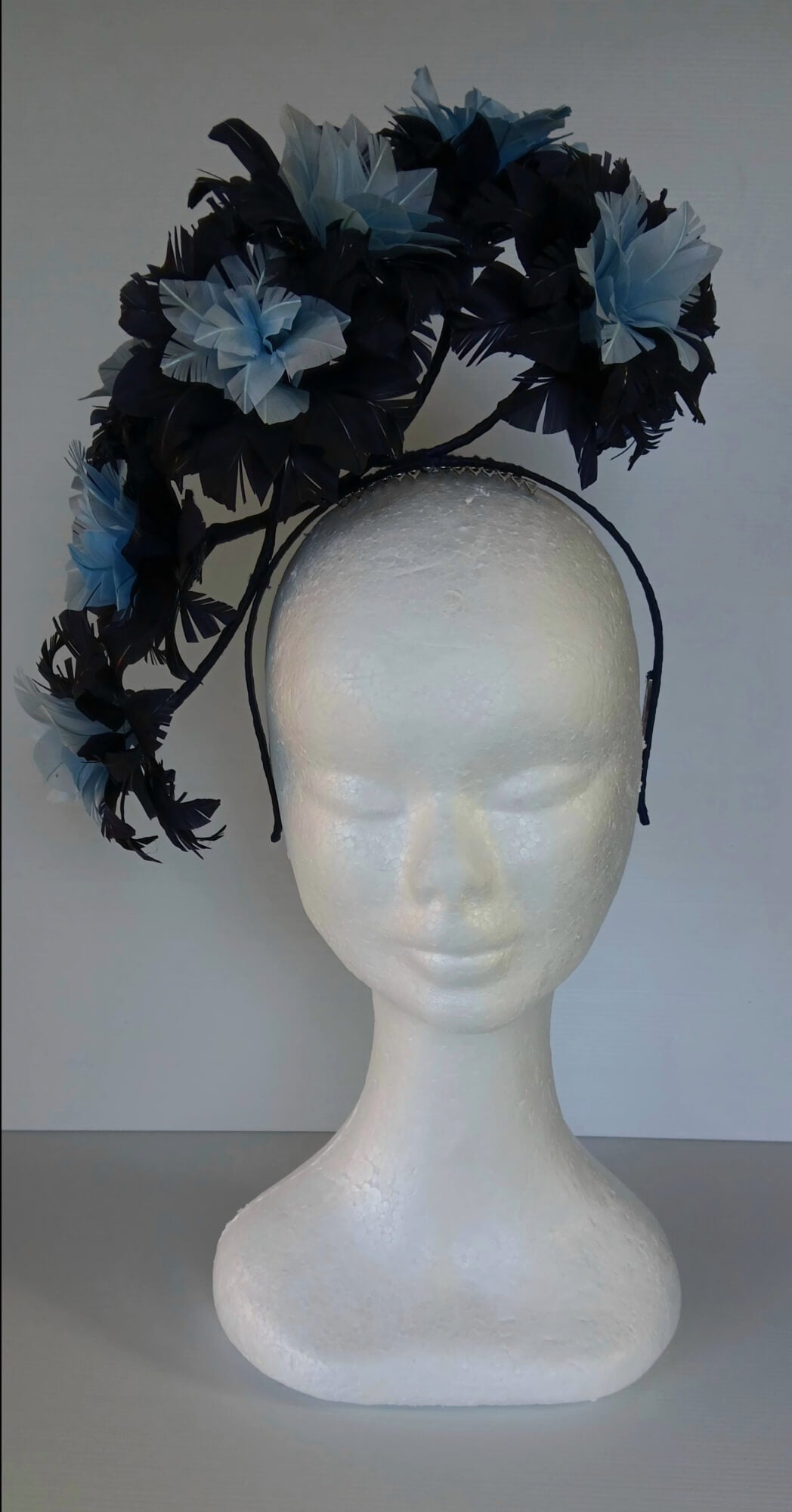 A picture of a Blue Floating Feather Millinery Headpiece by Melissa Rath Millinery.