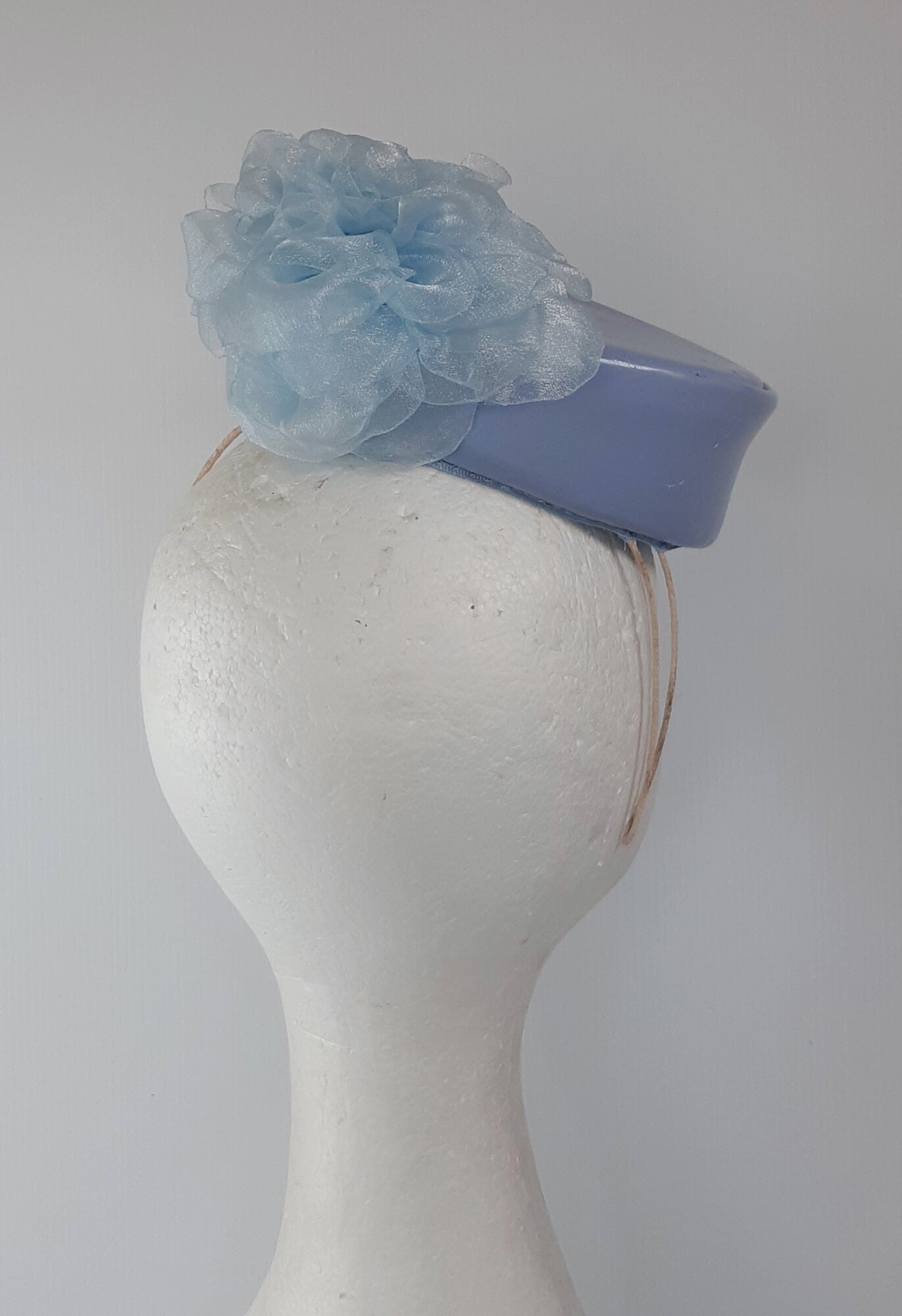 A picture of a Blue Leather Millinery Headpiece by Melissa Rath Millinery.
