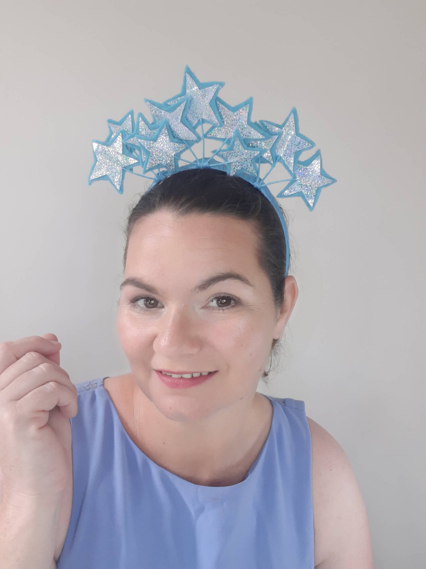 A picture of a blue millinery headband with stars  by Melissa Rath Millinery.