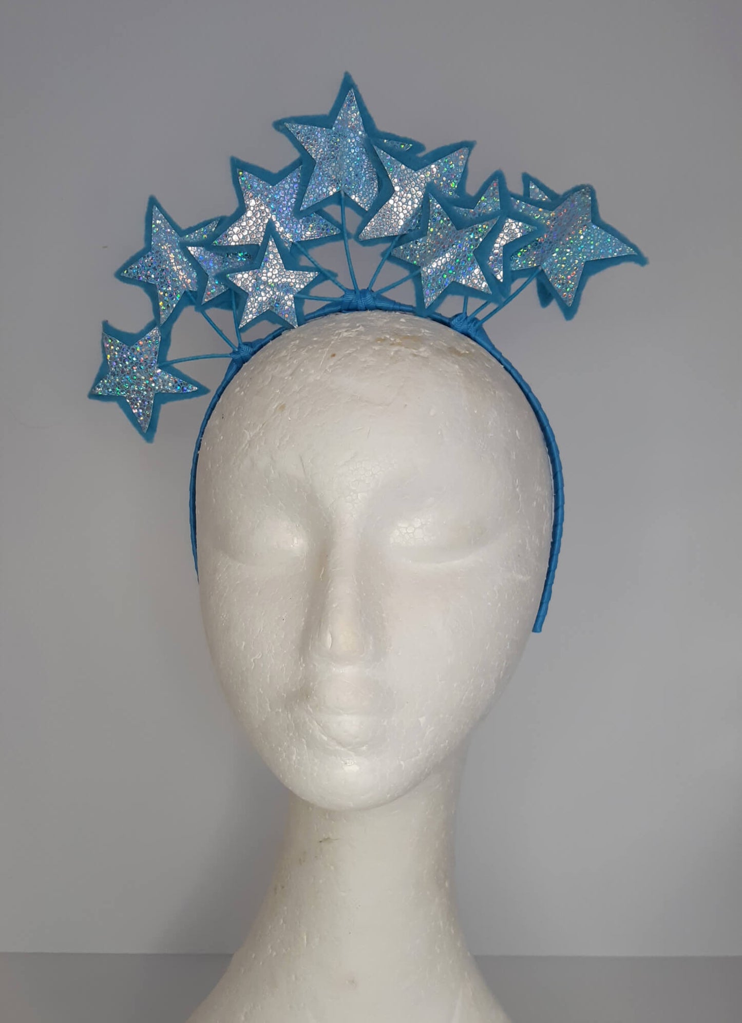A picture of a blue millinery headband with stars  by Melissa Rath Millinery.