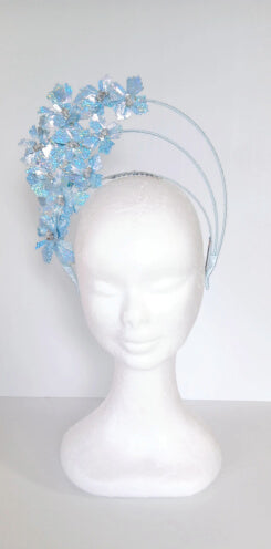 A picture of a blue pleather millinery halo crown by Melissa Rath Millinery.