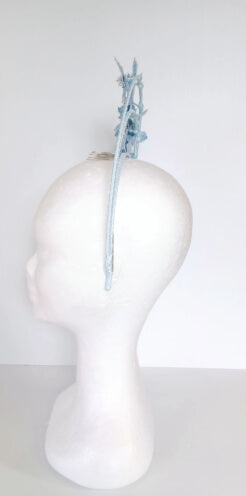 A picture of a blue pleather millinery halo crown by Melissa Rath Millinery.