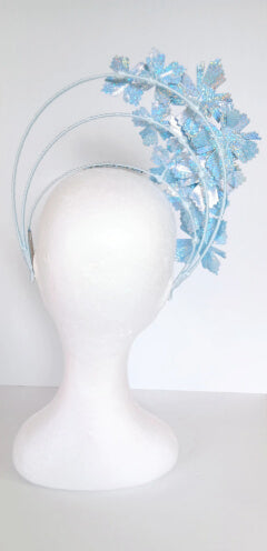A picture of a blue pleather millinery halo crown by Melissa Rath Millinery.