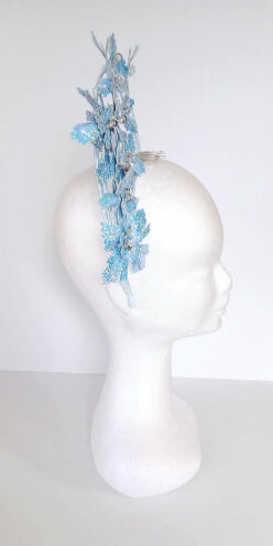 A picture of a blue pleather millinery halo crown by Melissa Rath Millinery.