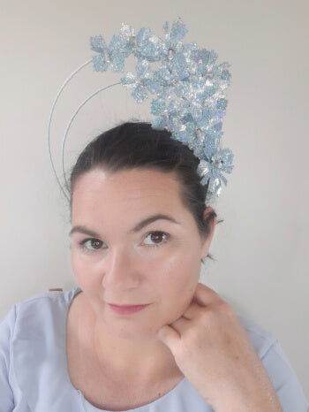 A picture of a blue pleather millinery halo crown by Melissa Rath Millinery.