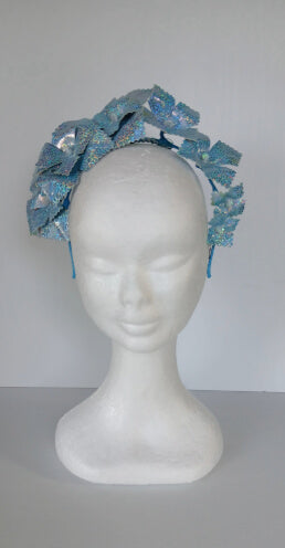A picture of a blue pleather millinery crown by Melissa Rath Millinery.