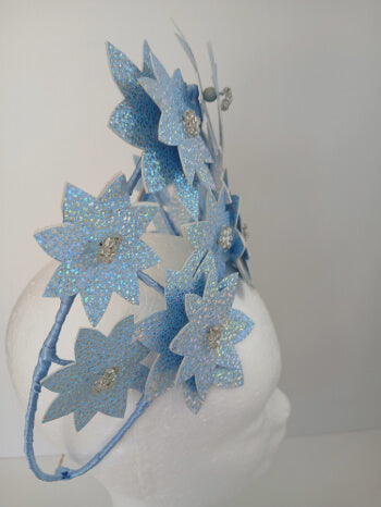 A picture is a Blue Pleather Millinery Crown by Melissa Rath Millinery.