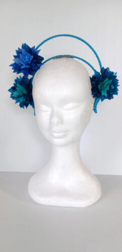 A picture of a blue and green feathered halo crown by Melissa Rath Millinery