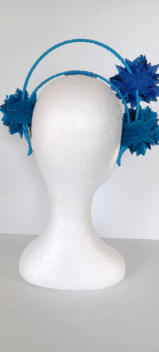 A picture of a blue and green feathered halo crown by Melissa Rath Millinery