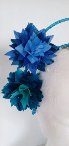 A picture of a blue and green feathered halo crown by Melissa Rath Millinery
