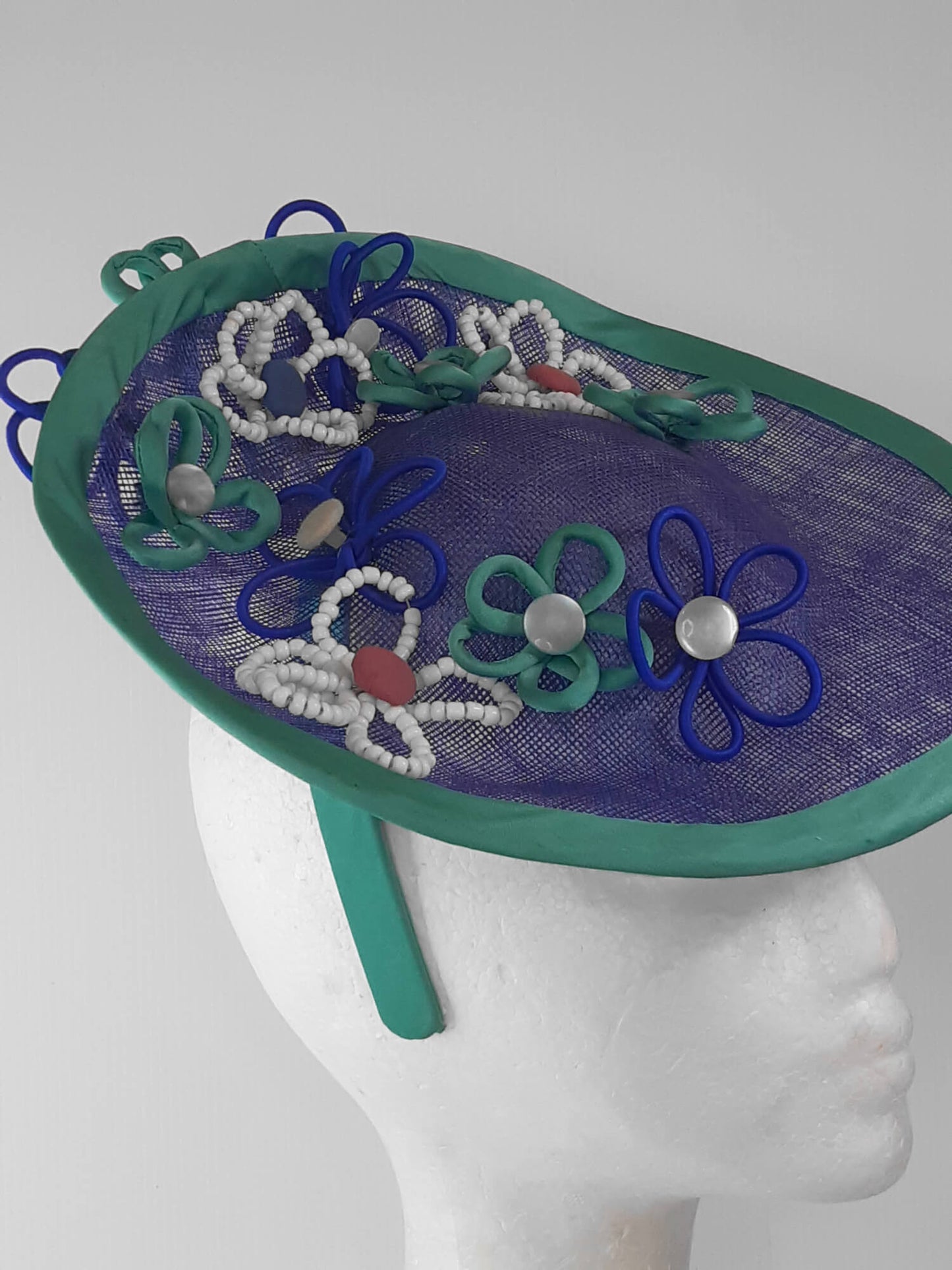 A picture of a Blue and Green Saucer Hat by Melissa Rath Millinery.