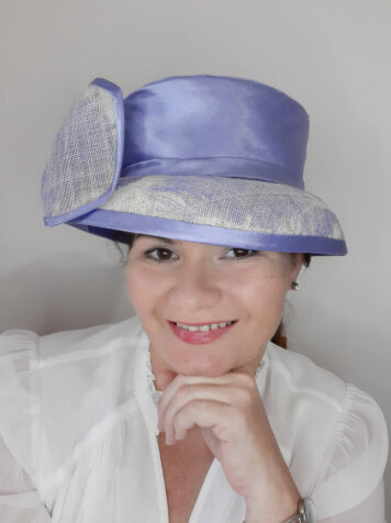 A picture of a blue and white picture hat by Melissa Rath Millinery.