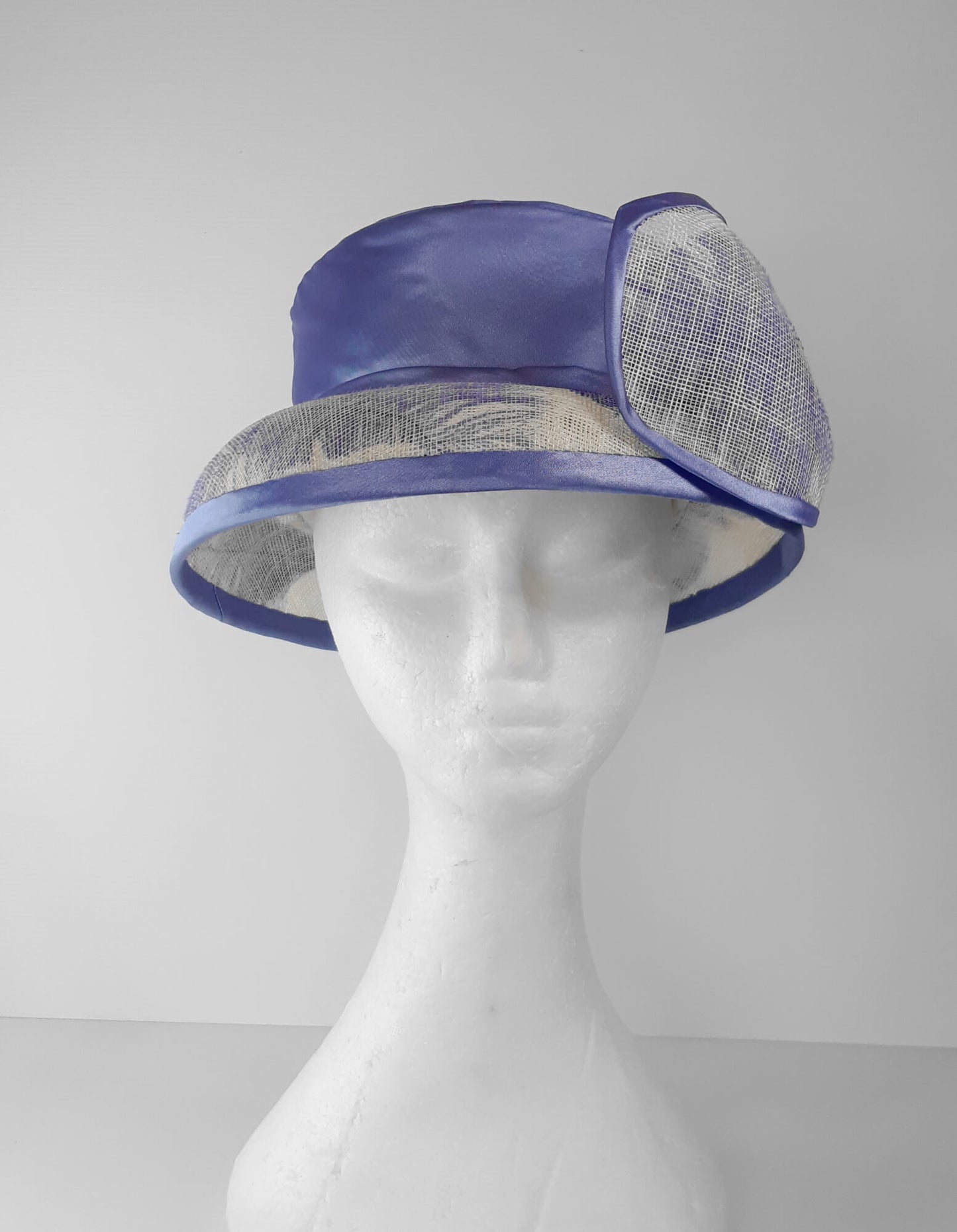 A picture of a blue and white picture hat by Melissa Rath Millinery.