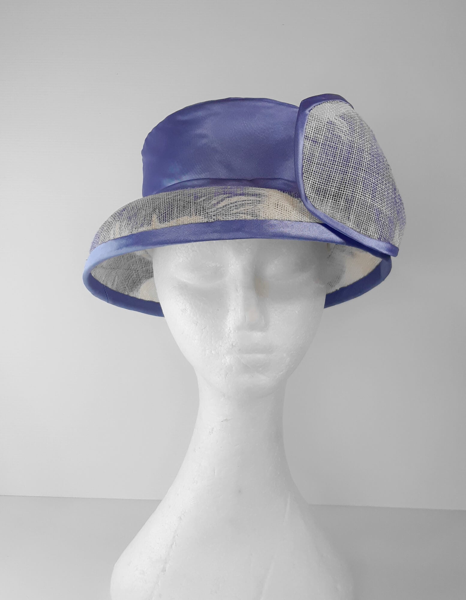 A picture of a blue and white picture hat by Melissa Rath Millinery.