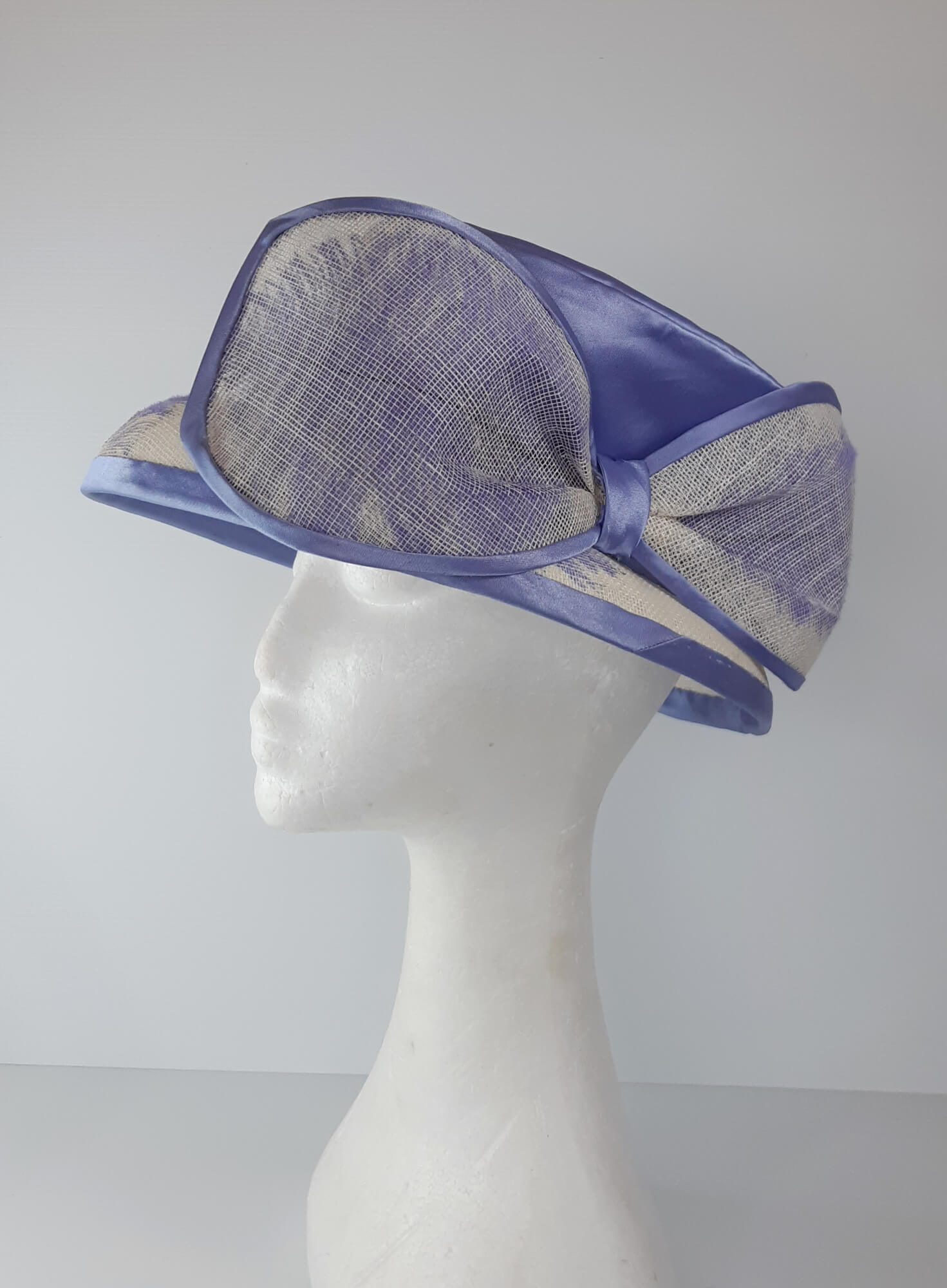 A picture of a blue and white picture hat by Melissa Rath Millinery.