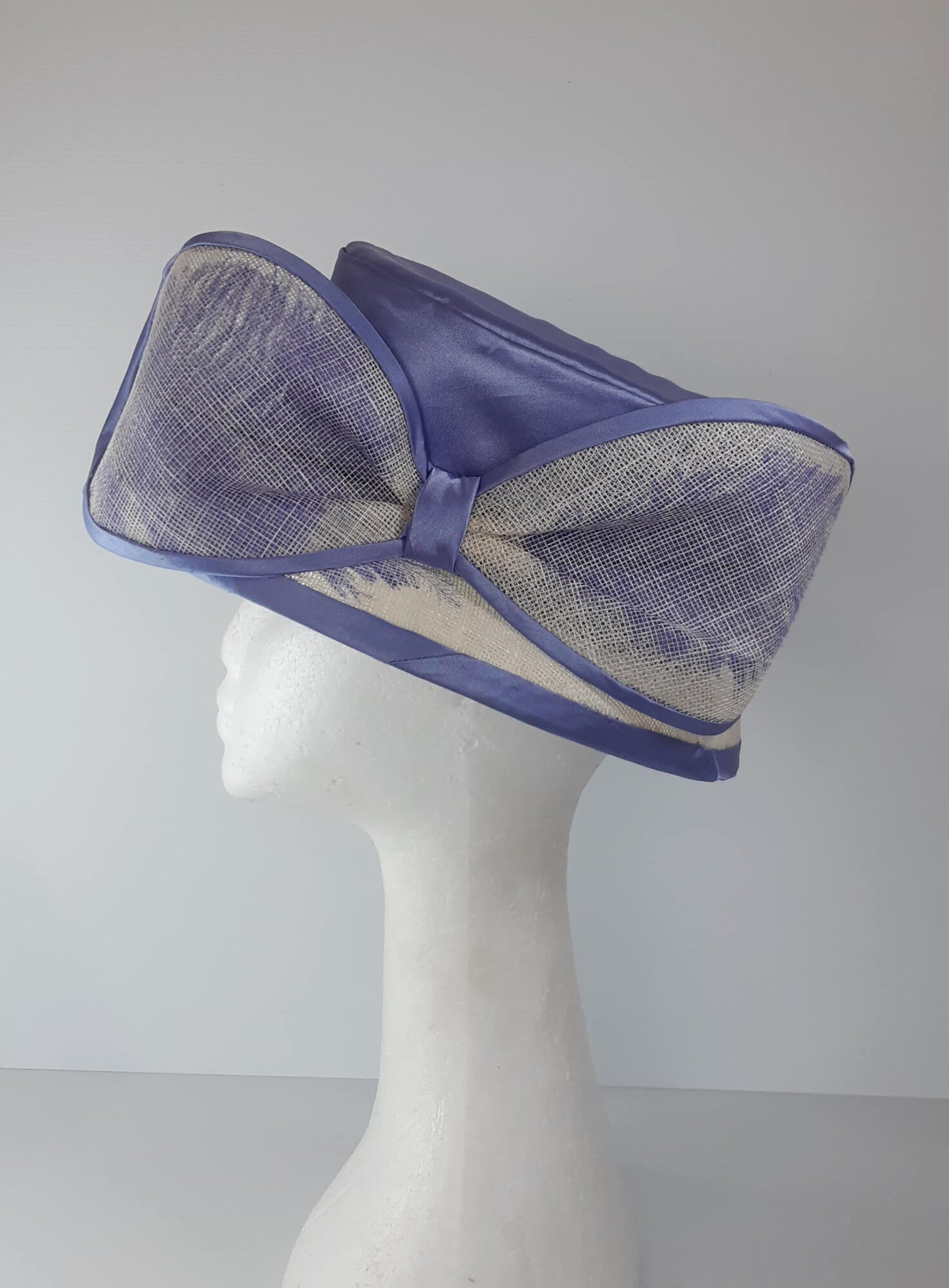 A picture of a blue and white picture hat by Melissa Rath Millinery.