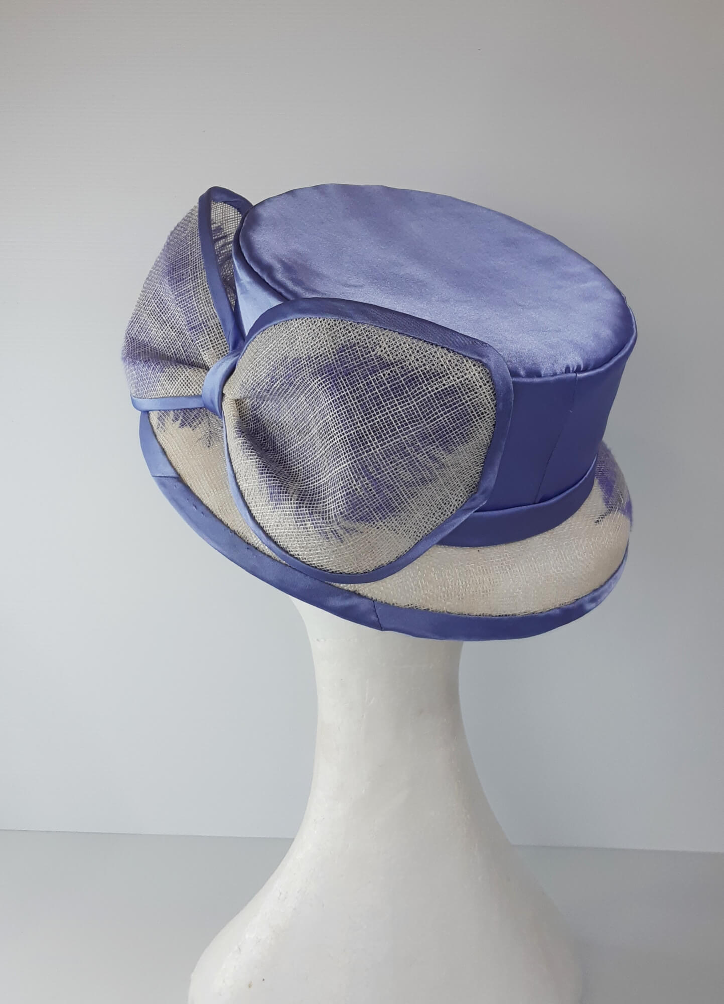 A picture of a blue and white picture hat by Melissa Rath Millinery.