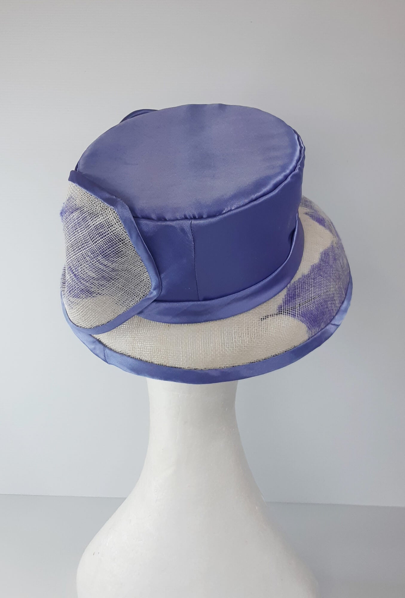 A picture of a blue and white picture hat by Melissa Rath Millinery.