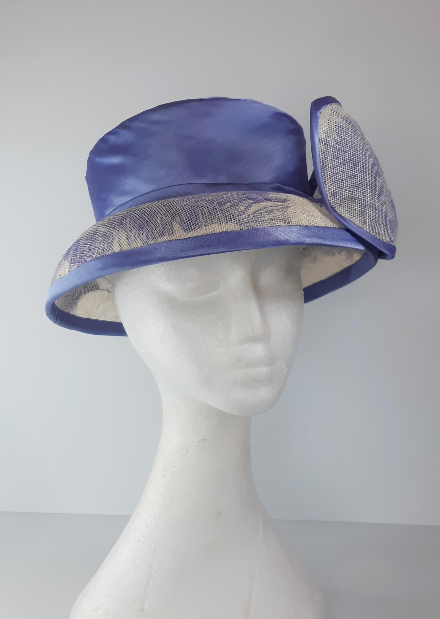A picture of a blue and white picture hat by Melissa Rath Millinery.