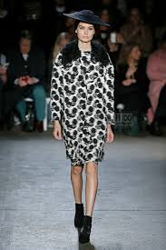 A picture of a model on the catwalk for  Christian Siriano FW 2014.