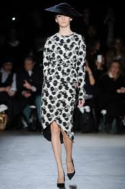 A picture of a model on the catwalk for  Christian Siriano FW 2014.