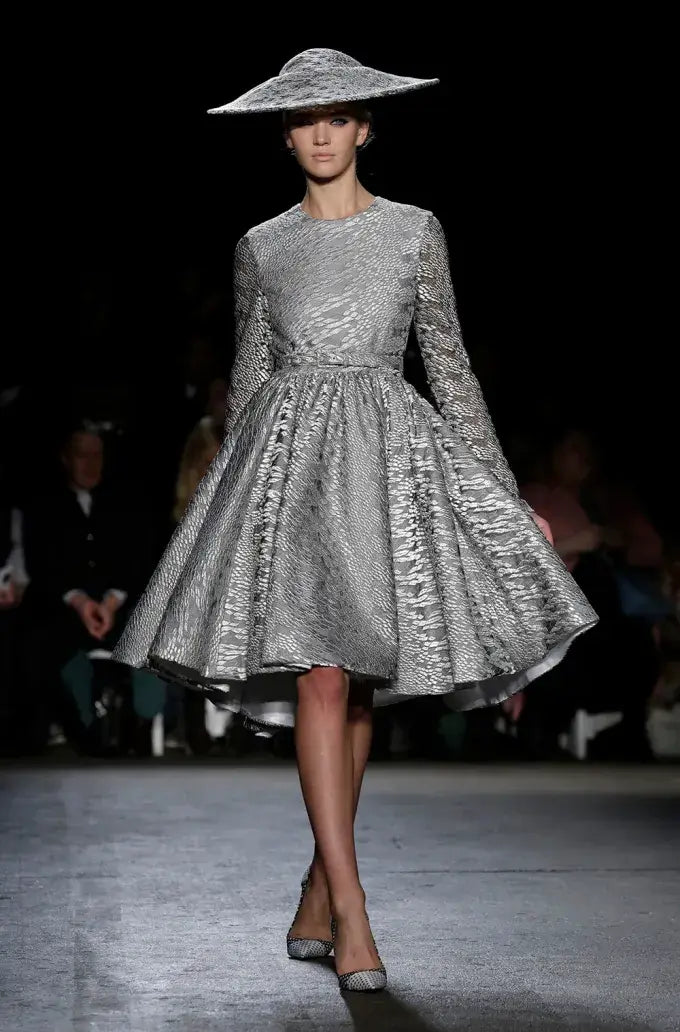 A picture of a model on the catwalk for  Christian Siriano FW 2014.