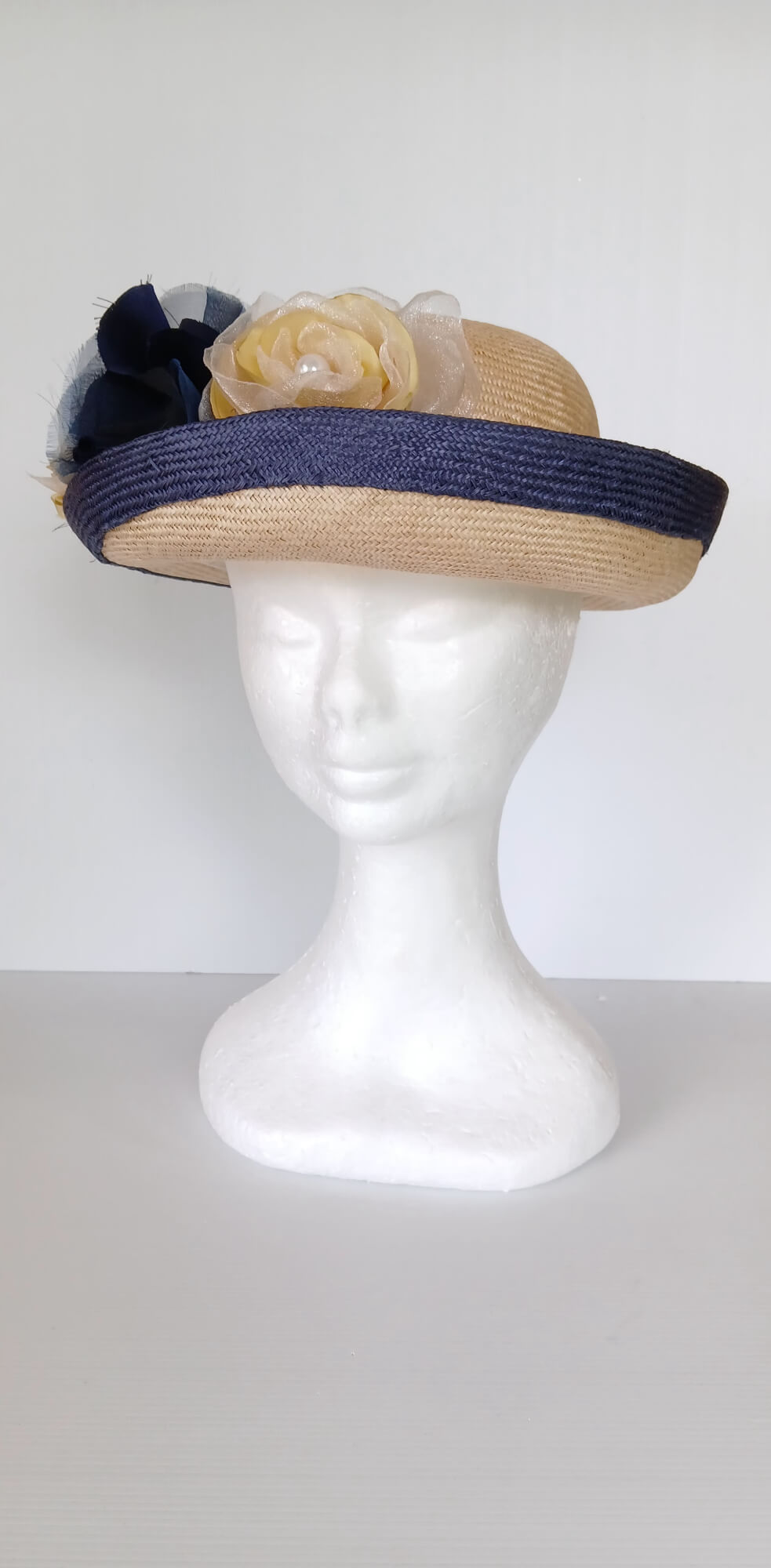 A picture of a Navy and Cream Parisisal Picture Hat by Melissa Rath Millinery.