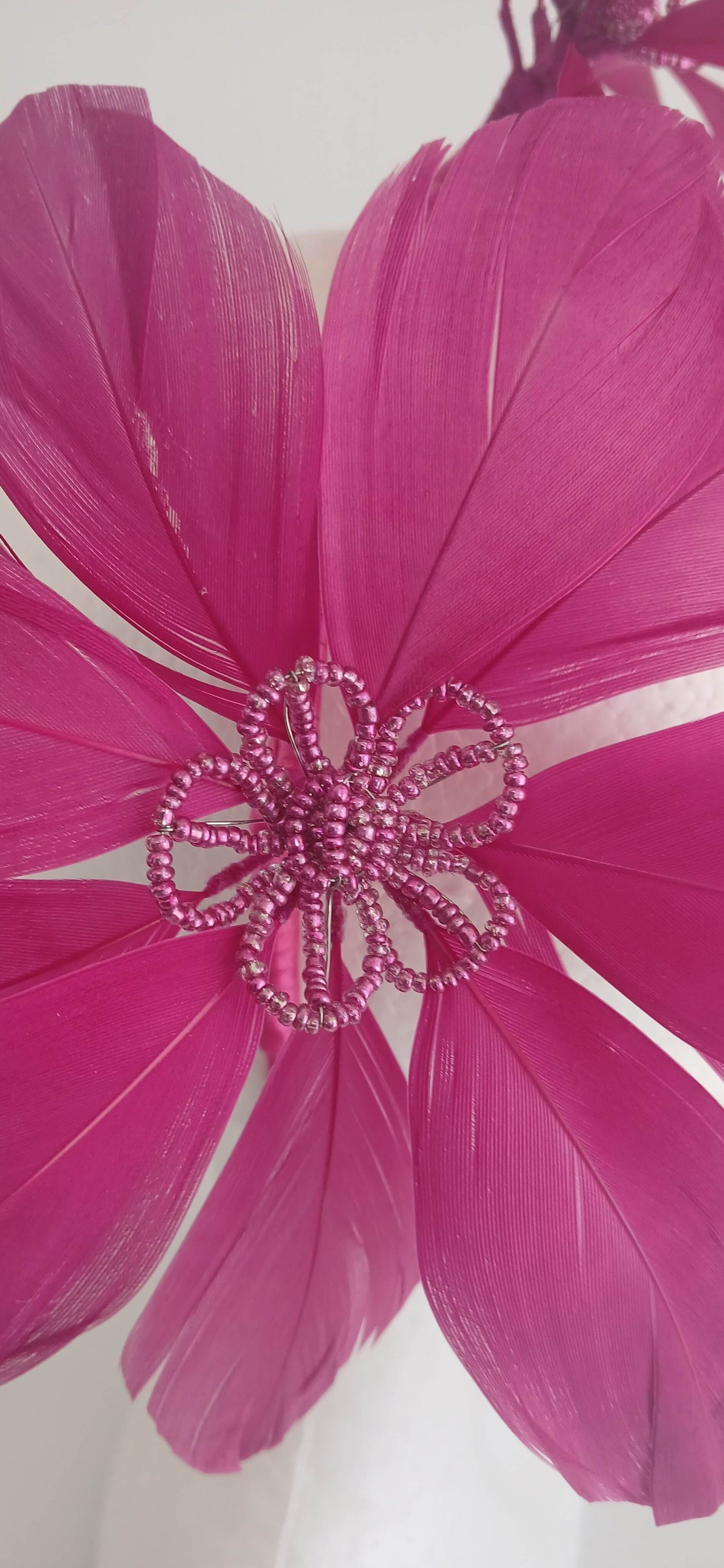 An image of the Dark Pink Feather Flower Headband by Melissa Rath Millinery