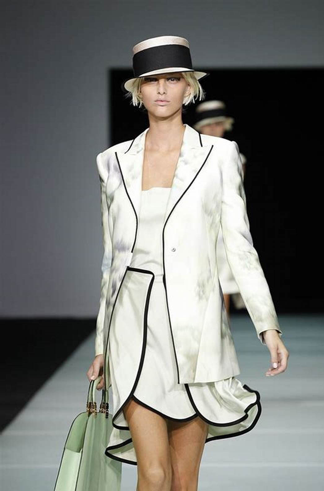 A picture of a model on the catwalk for  Emporio Armani SS 2012.