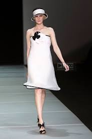 A picture of a model on the catwalk for  Emporio Armani SS 2012.
