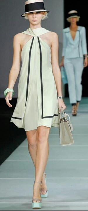 A picture of a model on the catwalk for  Emporio Armani SS 2012.