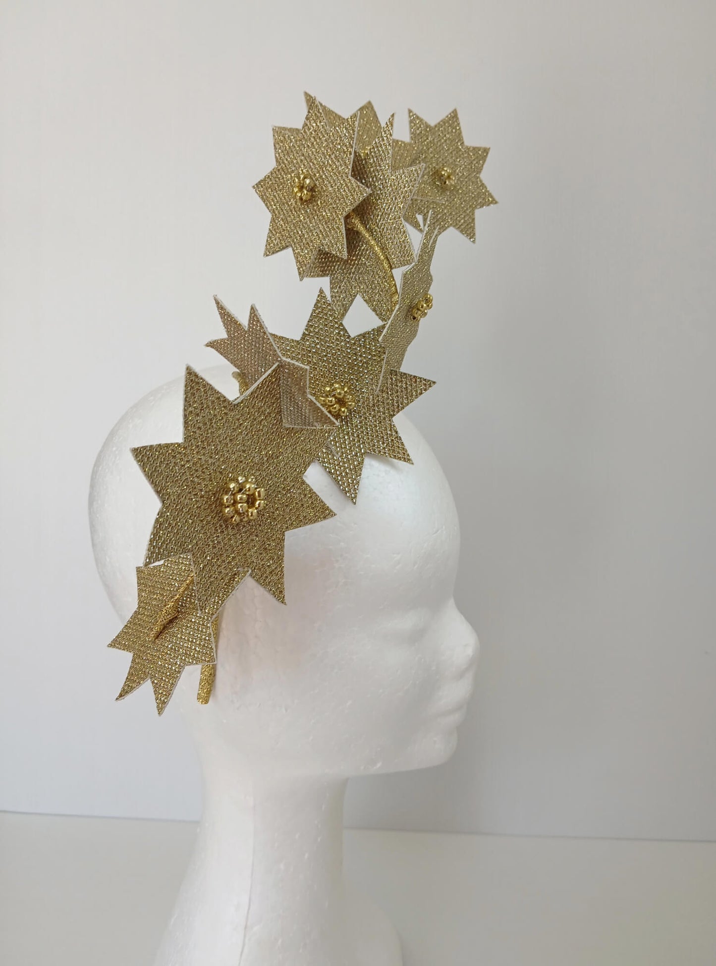 A picture of a Gold Pleather Millinery Fascinator by Melissa Rath Millinery