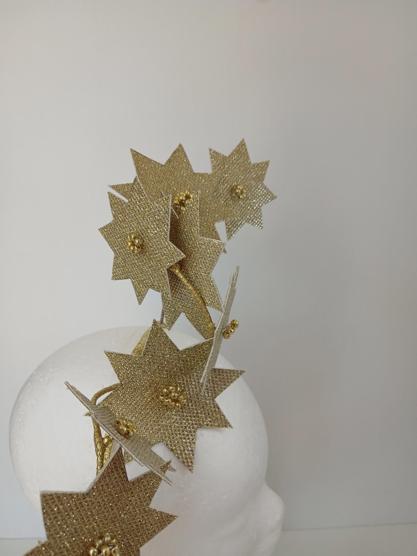 A picture of a Gold Pleather Millinery Fascinator by Melissa Rath Millinery