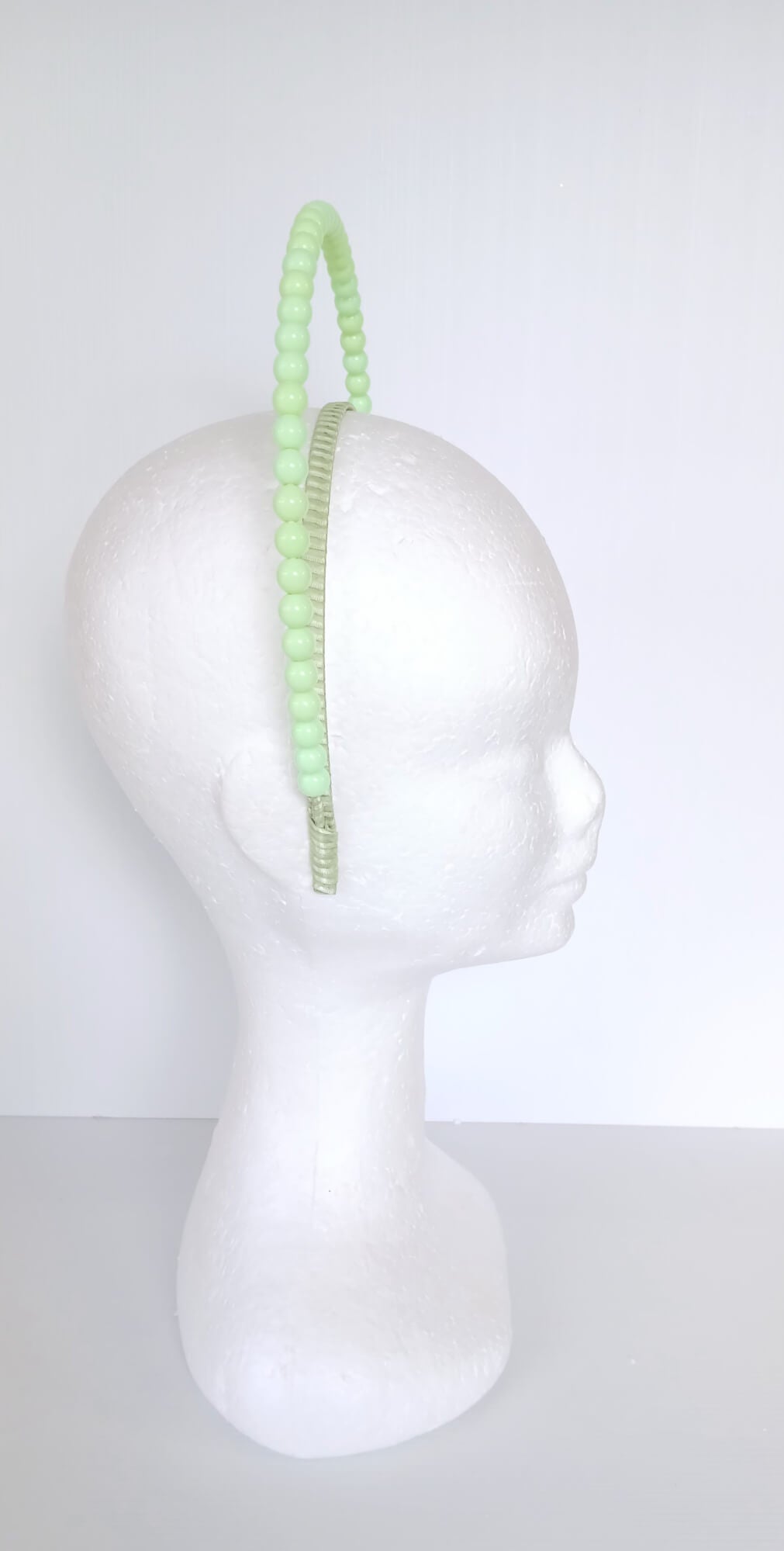 A picture of a Green Beaded Headband by Melissa Rath Millinery